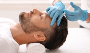Man laying down get PRP injections in his head for hair growth in Leesburg, FL